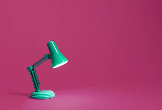 The same desk lamp on its original magenta backdrop