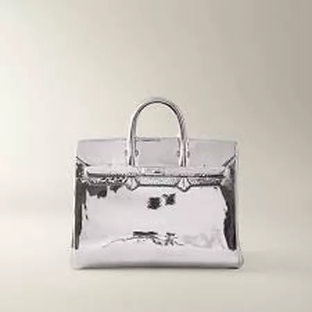 Silver handbag stock JPEG before background removal, shot on a plain studio backdrop