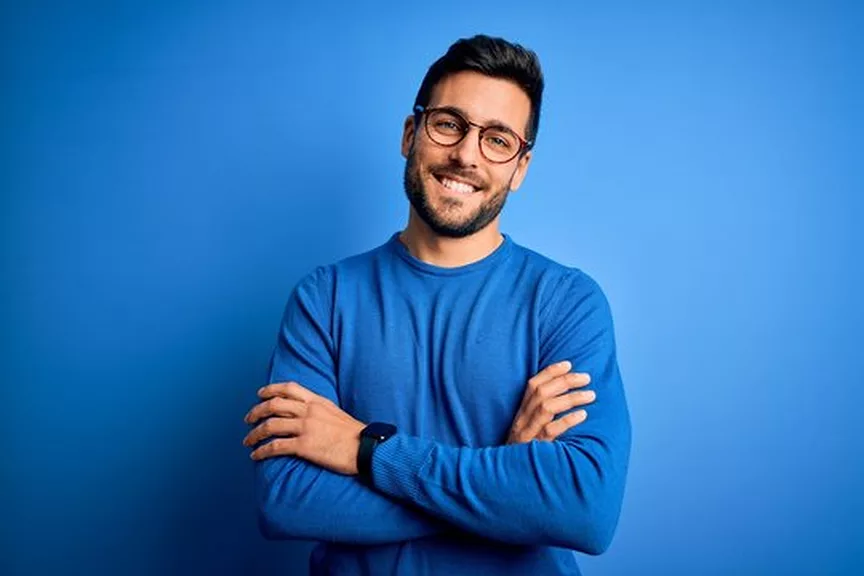 Portrait headshot JPG before background removal, shot against a plain blue backdrop
